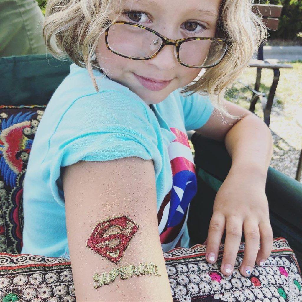 Girl with SuperGirl henna tattoo