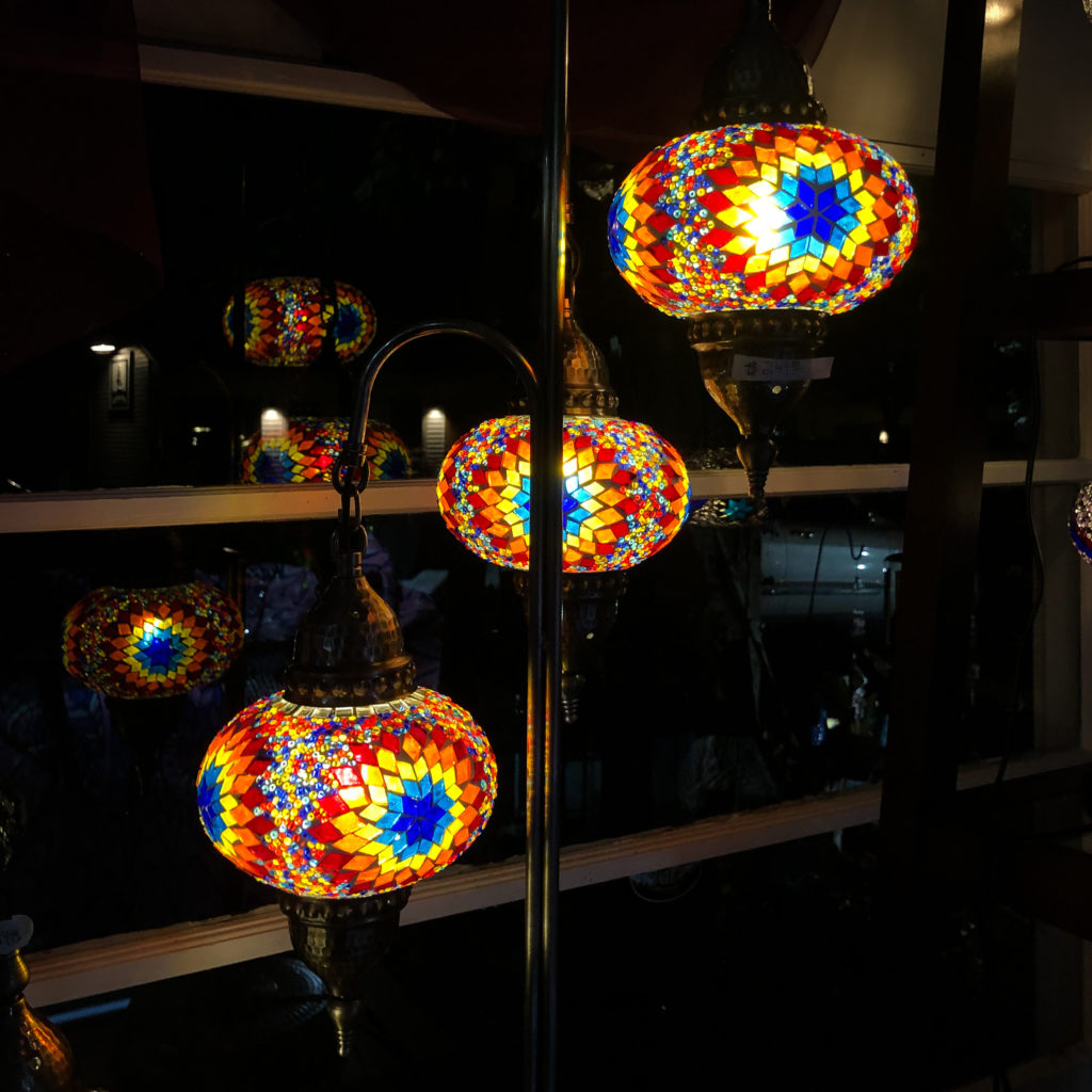 Turkish lamp shades reflect in the window at night